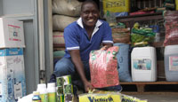 Micheal purchasing seeds and pesticides for distribution in the community